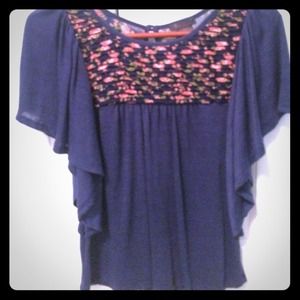 Navy shirt with roses at the top.