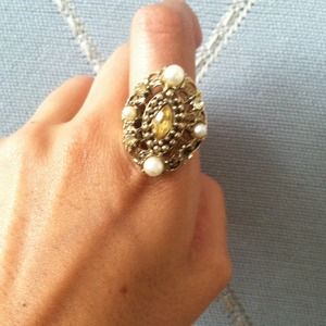 Antique gold metal ring with gems and pearls.