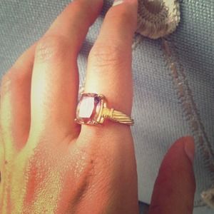 Light purple gemstone and gold ring.