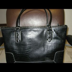 Black handbag manmade durable material for work .