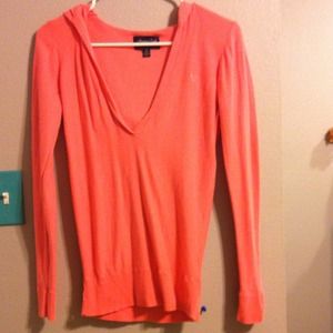 A coral v-neck pullover