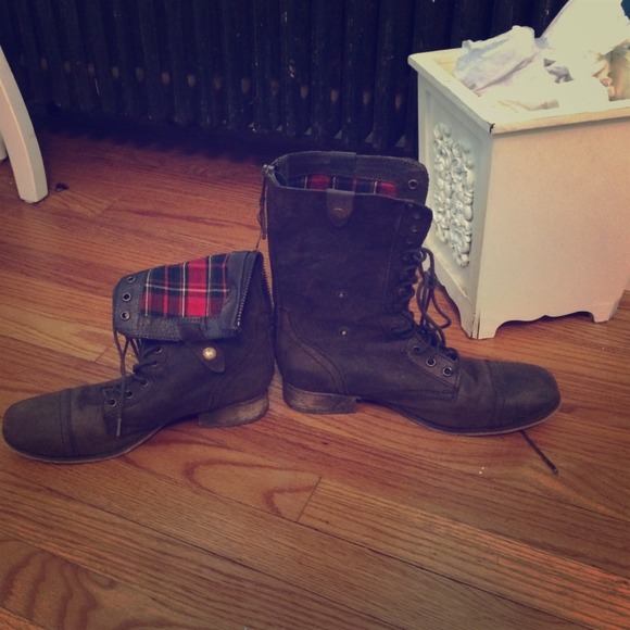 Dark brown combat boots with plaid on the inside