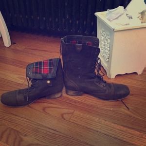 Dark brown combat boots with plaid on the inside