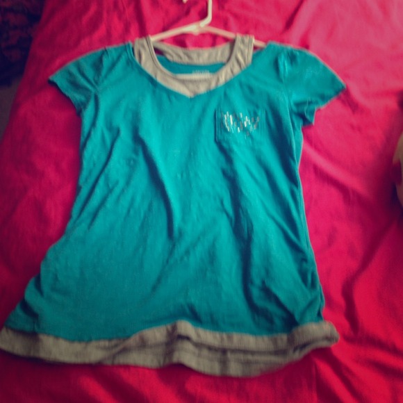 Short sleeved blue shirt with gray tank top under