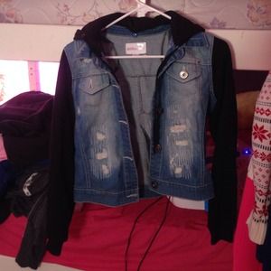 Jean jacket with black sleeves and hood.