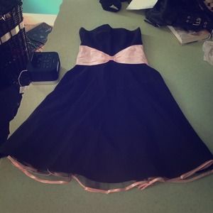 Black strapless dress with pink bow belt