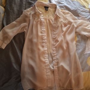 A cream sheer three quarter sleeve shirt.
