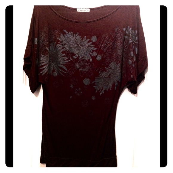 Brown top with detailed print on front.