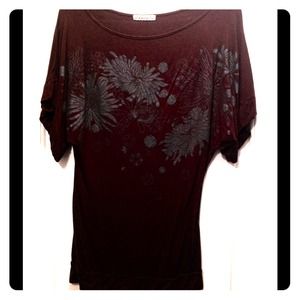 Brown top with detailed print on front.
