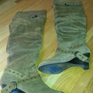 Thigh high brown suede boots.