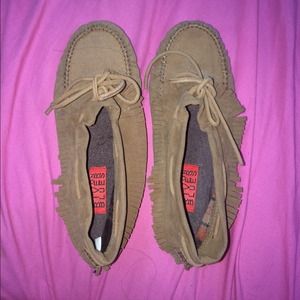 Tan moccasin boots with fringe