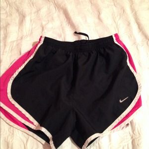 Black and pink Nike Dri-Fit running shorts.