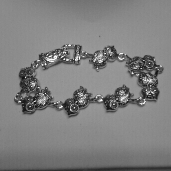 Cute silver in color owl bracelet.