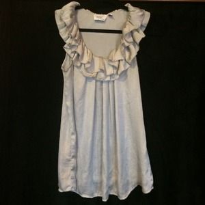 Silk oversized top with ruffle neckline. Silver
