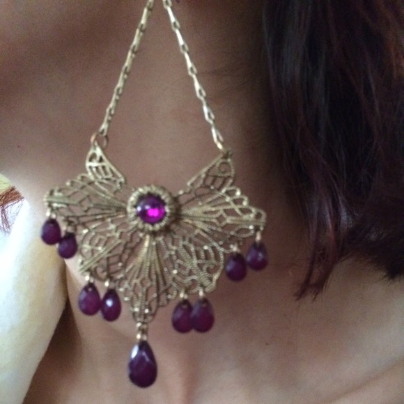 Gold dangling earrings with purple hanging gems. - Picture 2 of 3
