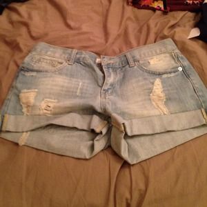 Torn blue jean shorts