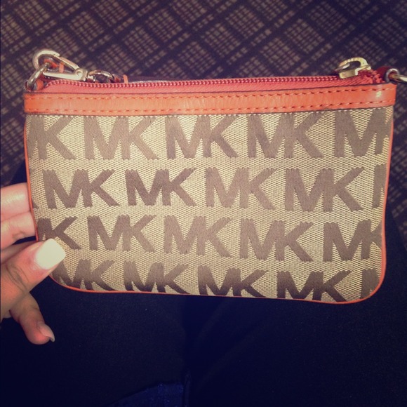 Authentic MK orange wristlet .