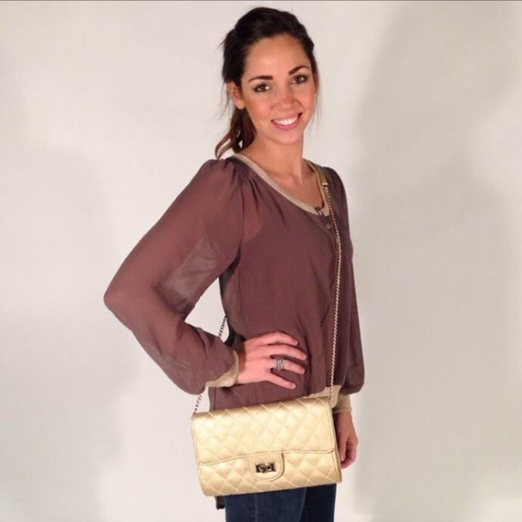 Gold faux leather clutch with attachable strap.