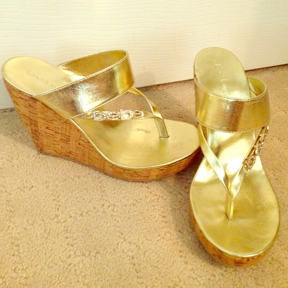 Gold high heel flip flops with cork heel