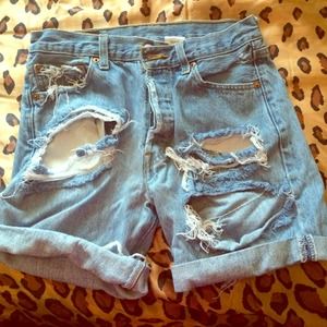 Cut up high waisted shorts .