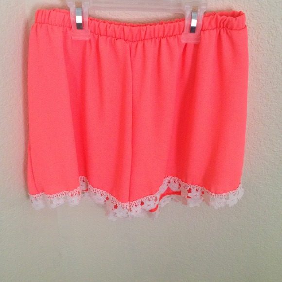 Neon orange dress shorts with lace trimming