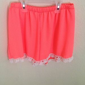 Neon orange dress shorts with lace trimming