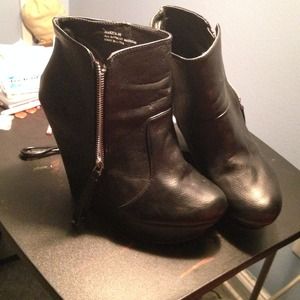 Wedge black booties with pull-up zipper sides.