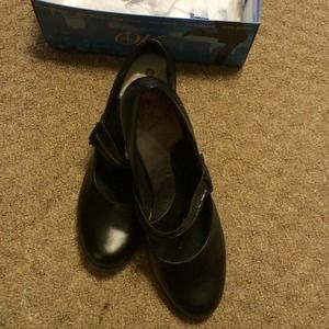 Black leather Mary Jane pumps.