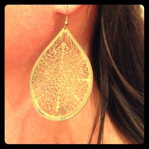 Gold earrings and a turquoise and silver bracelet