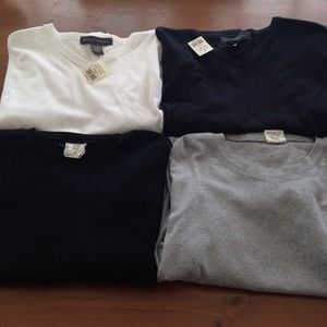 Four XL men's solid, long-sleeve shirts.