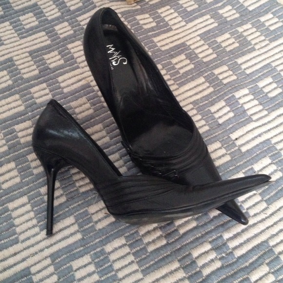 Super pointy black shoes with buckles.