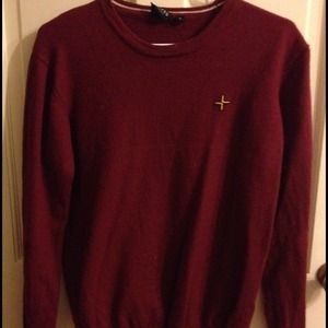 maroon sweater with small yellow plus sign