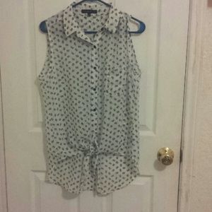 White sleeveless top with black skulls