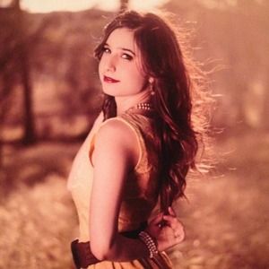 A knee high lace dress with a small braided belt.