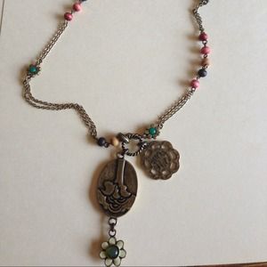 Long gold necklace with beading and pendant