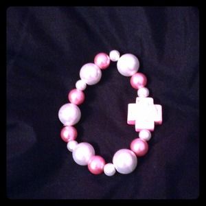 Pink cross bracelet.