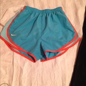Blue Nike Dri Fit shorts with blue/orange accents