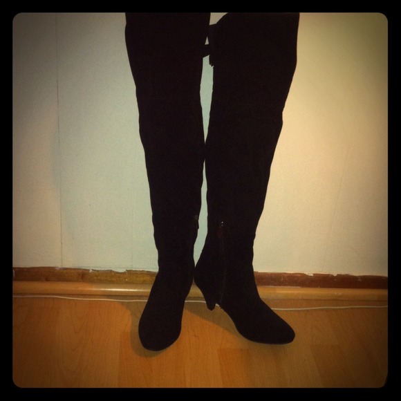 Long black boots with short heels