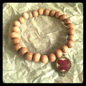 Stretchy wood bead bracelet with charm