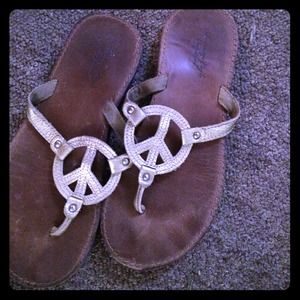 AE gold peace sign flip flops
