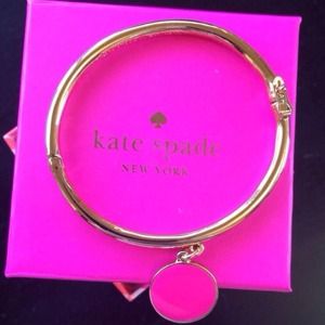 Kate Spade Gold bangle with hot pink charm