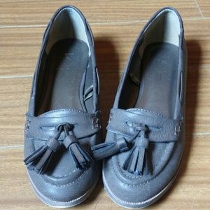 Brown leather loafers with tassel accents