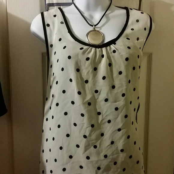 White polka dotted sleeveless blouse