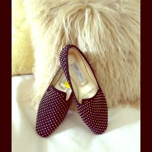 Jimmy Choo black suede flats with gold studs.