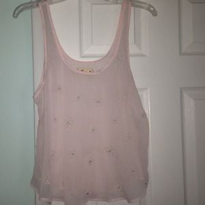 A sheer light pink tank top