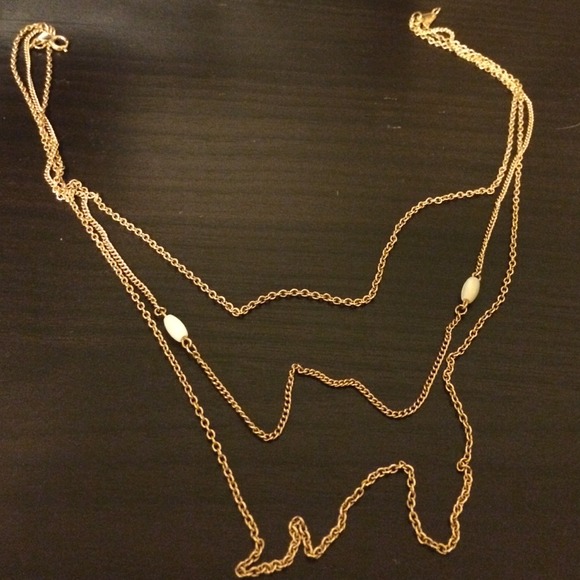 Gold played necklace with white stones