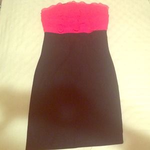 fitted black dress with pink ruffles