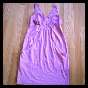 A casual dress with a low back & 2 front pockets.