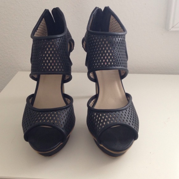 Black perforated platform heels with zippers