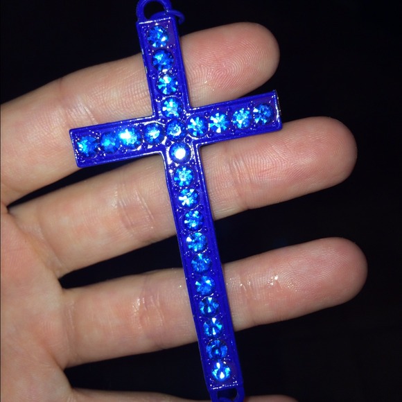 A royal blue cross necklace with blue crystals